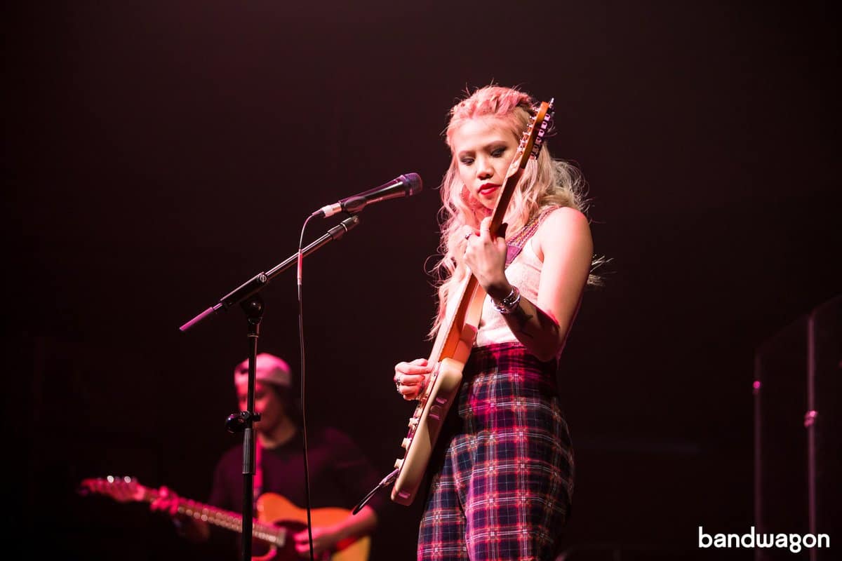 Joie Tan playing guitar at the 'Joie' album launch in 2018